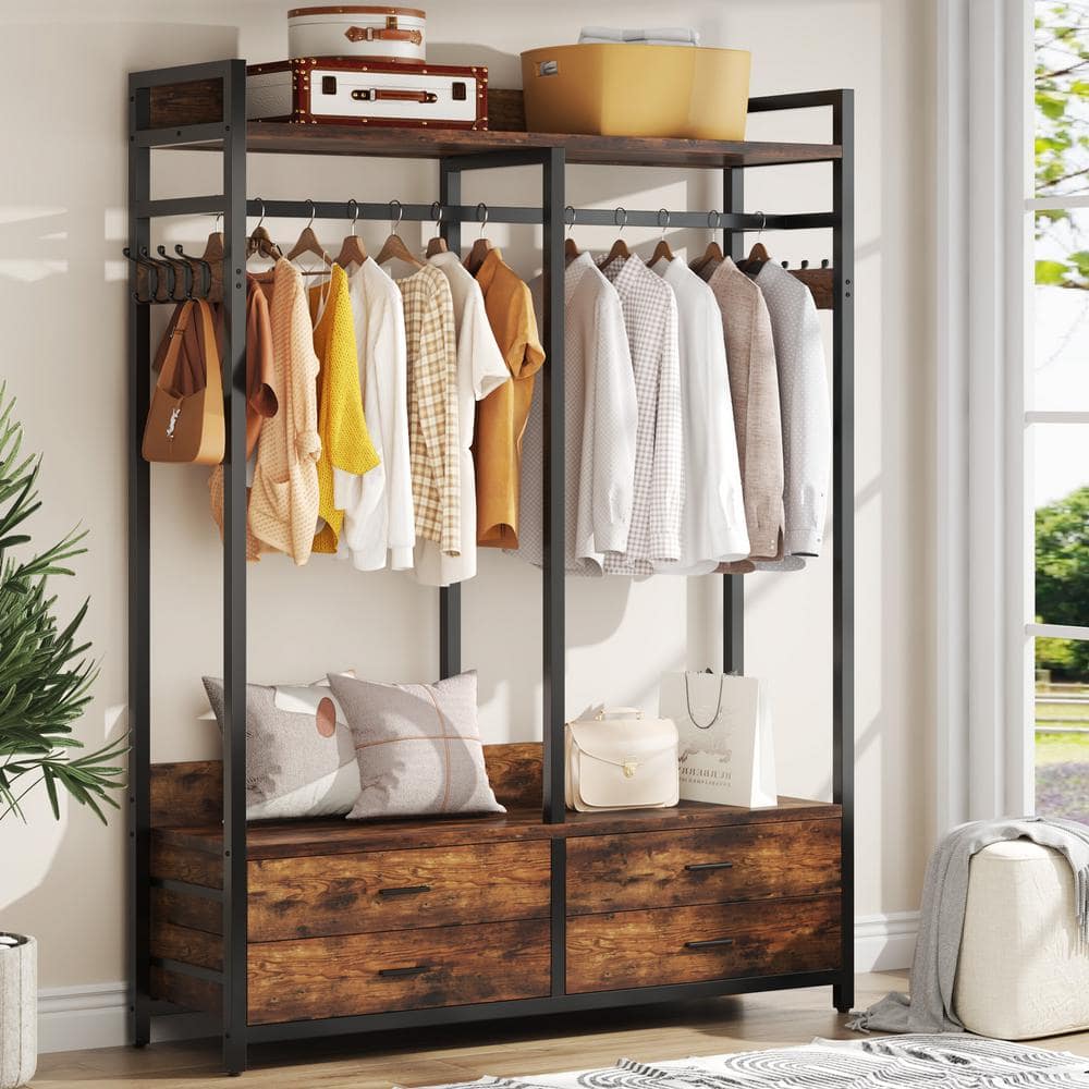 Black metal wardrobe with wooden base and hanging clothes.