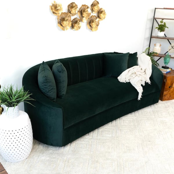 Curved green velvet sofa