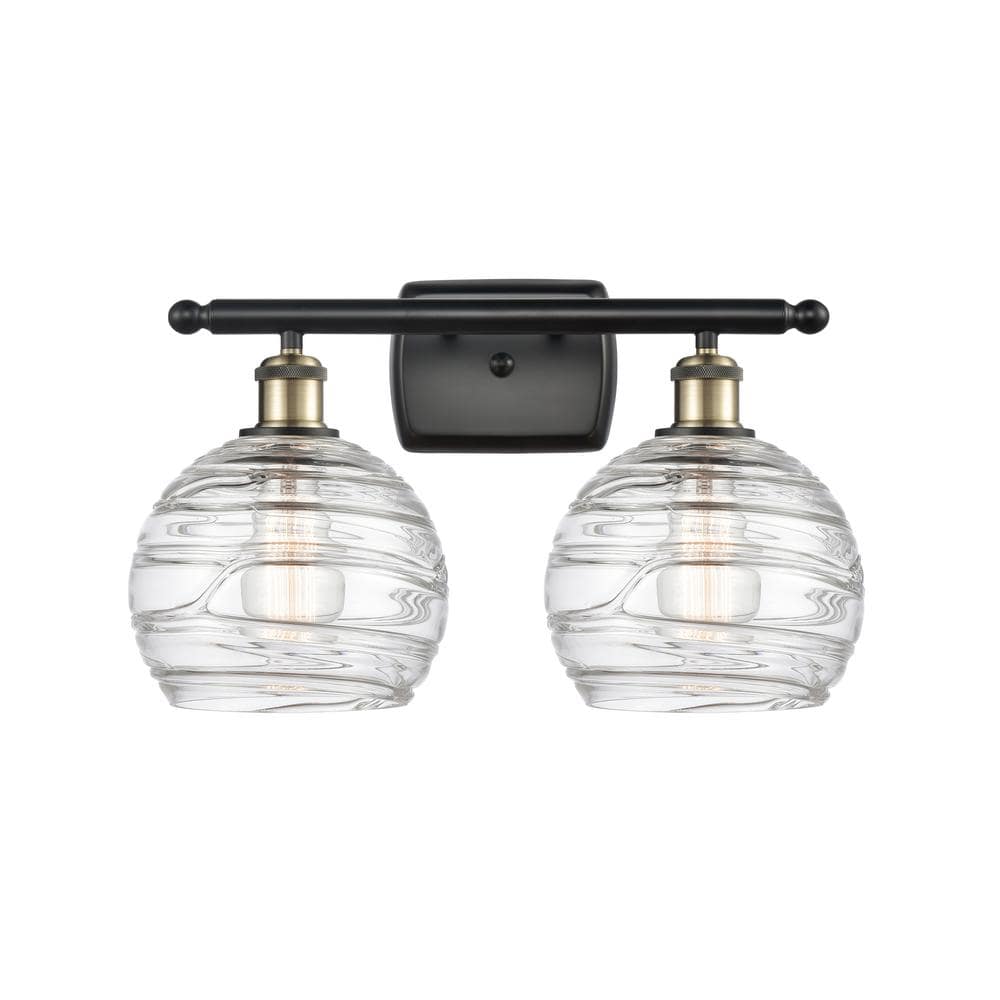 Athens Deco Swirl 18 in. 2-Light Black Antique Brass Vanity Light with Clear Deco Swirl Glass Shade -  Innovations, 516-2W-BAB-G121