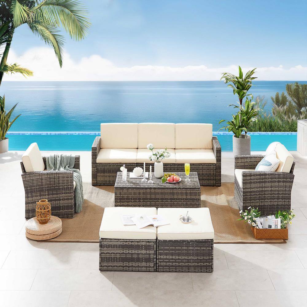 Wicker outdoor sofa set with khaki cushions by a pool.
