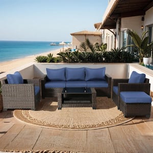 Outdoor Furniture Set 7-Piece Rattan Sectional Outdoor Seating with Wicker Sofas, Ottomans, Dark Blue Cushions, Table