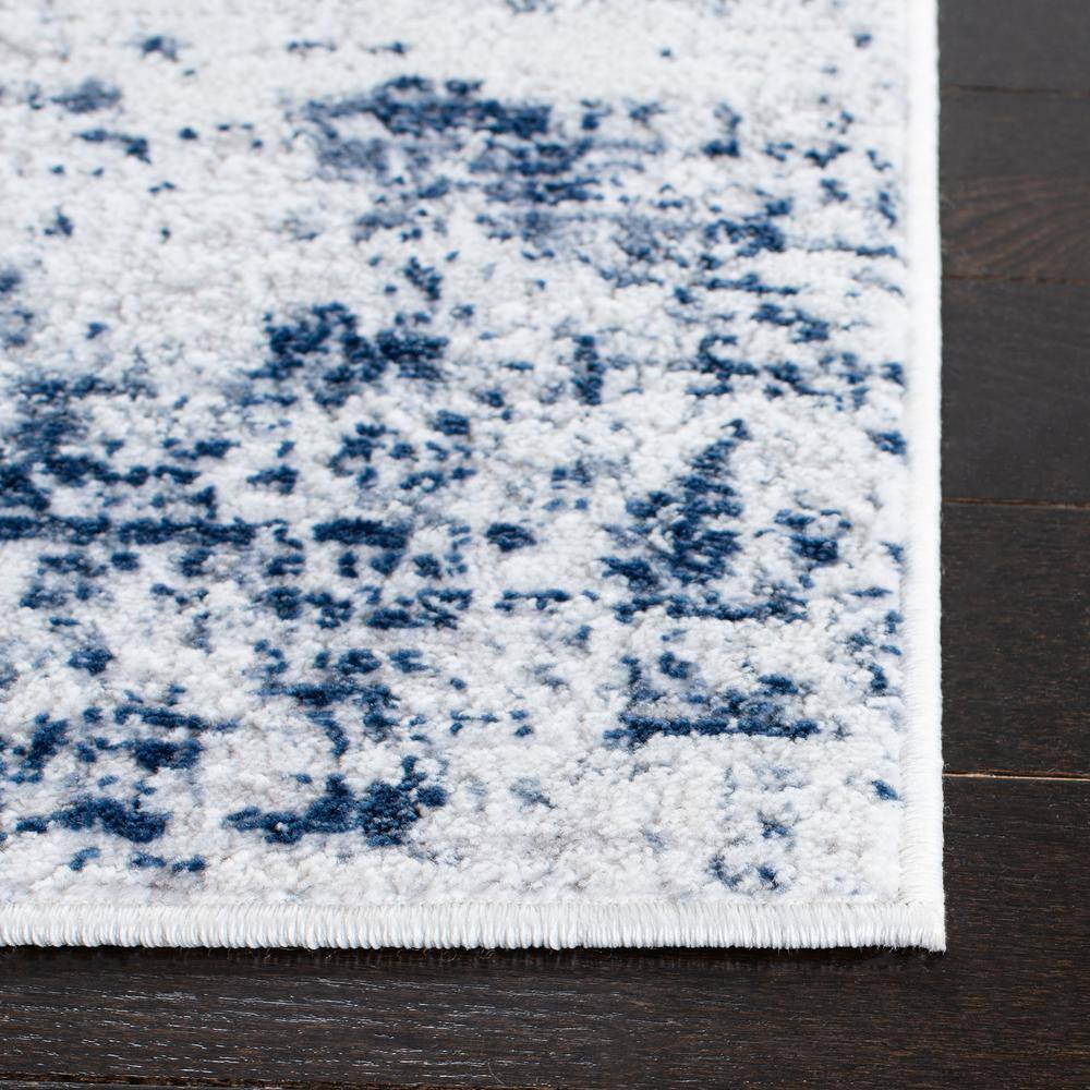 Ivory and Navy Abstract Synthetic Round Rug, 4' x 6'