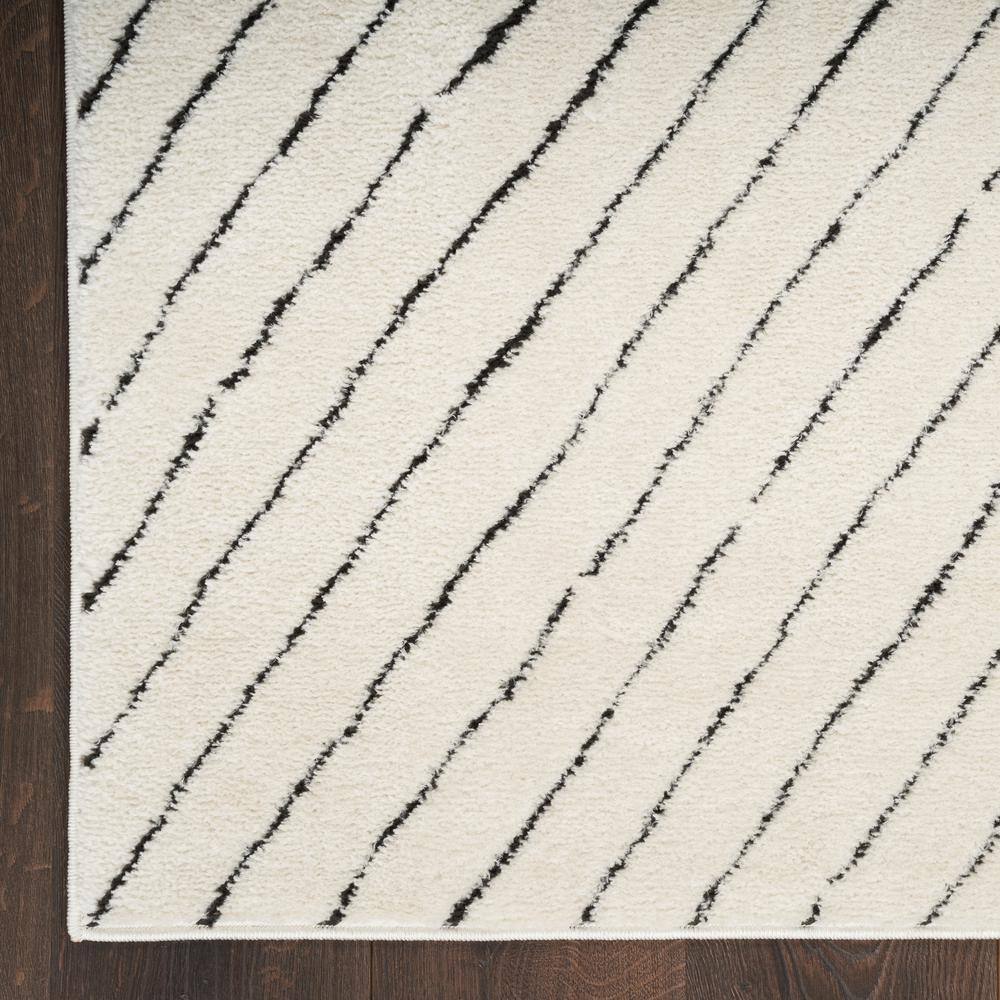 Ivory and Black Chevron Striped 5' x 7' Synthetic Area Rug