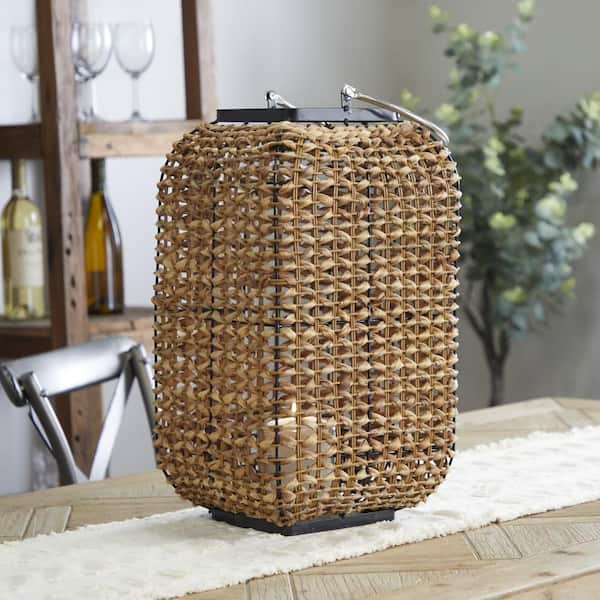 Litton Lane 20 in. H Brown Dried Plant Handmade Rattan Weaved Decorative Candle Lantern with Glass Holder and Handle