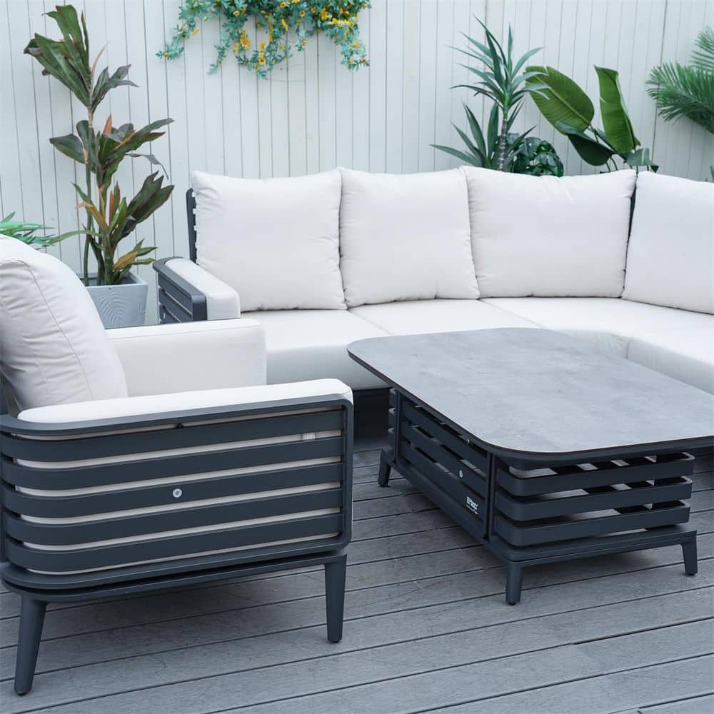 Close-up of dark grey wicker outdoor chair frame and cushions.