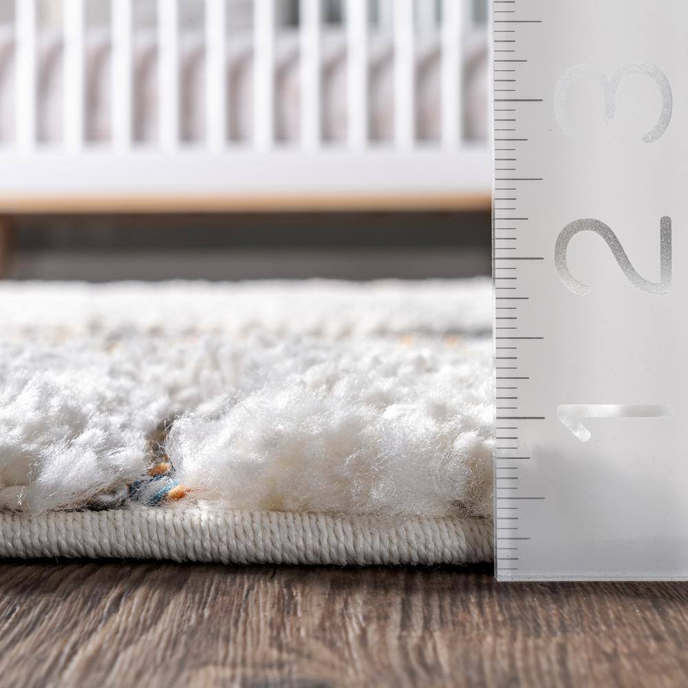 Ivory Geometric Synthetic Rectangular Area Rug with Braided Tassels
