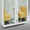 White office sound pod booth with yellow chairs visible through the door.