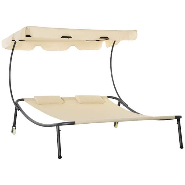 Black metal outdoor chaise lounge with a beige canopy and two pillows.