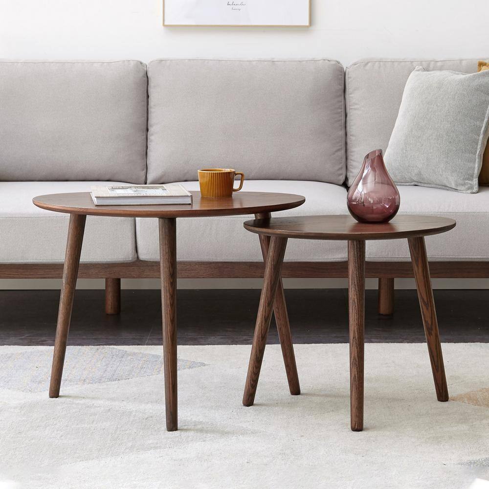 Two dark brown pebble-shaped oak wood coffee tables of different heights