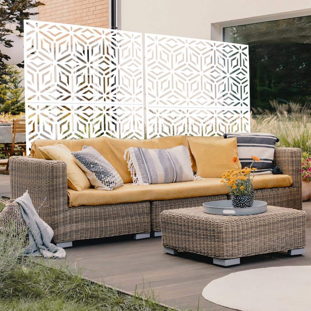 White geometric metal privacy screen in a patio setting with outdoor furniture.