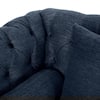 Close-up of the tufted fabric on the backrest of the loveseat.
