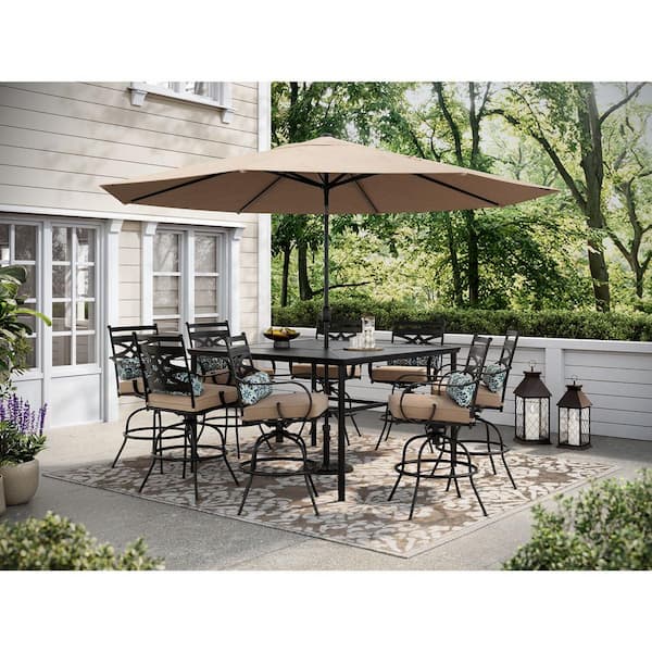 Hanover Montclair 9-Piece Steel Outdoor Dining Set with Tan Cushions, 8 Swivel Chairs and 60 in. Counter Height Table
