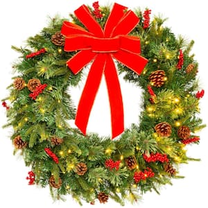 24 in. Battery Operated Pre-Lit Incandescent Artificial Christmas Wreath with Berries, Pine Cones, Ribbon