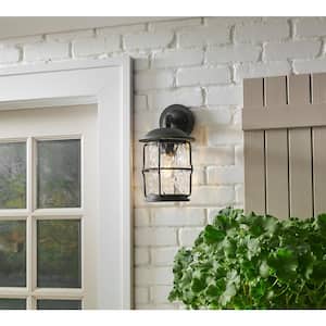 Hargreaves 13.5 in. 1-Light Gilded Iron Rustic Farmhouse Outdoor Wall Light Lantern Sconce with Seeded Glass