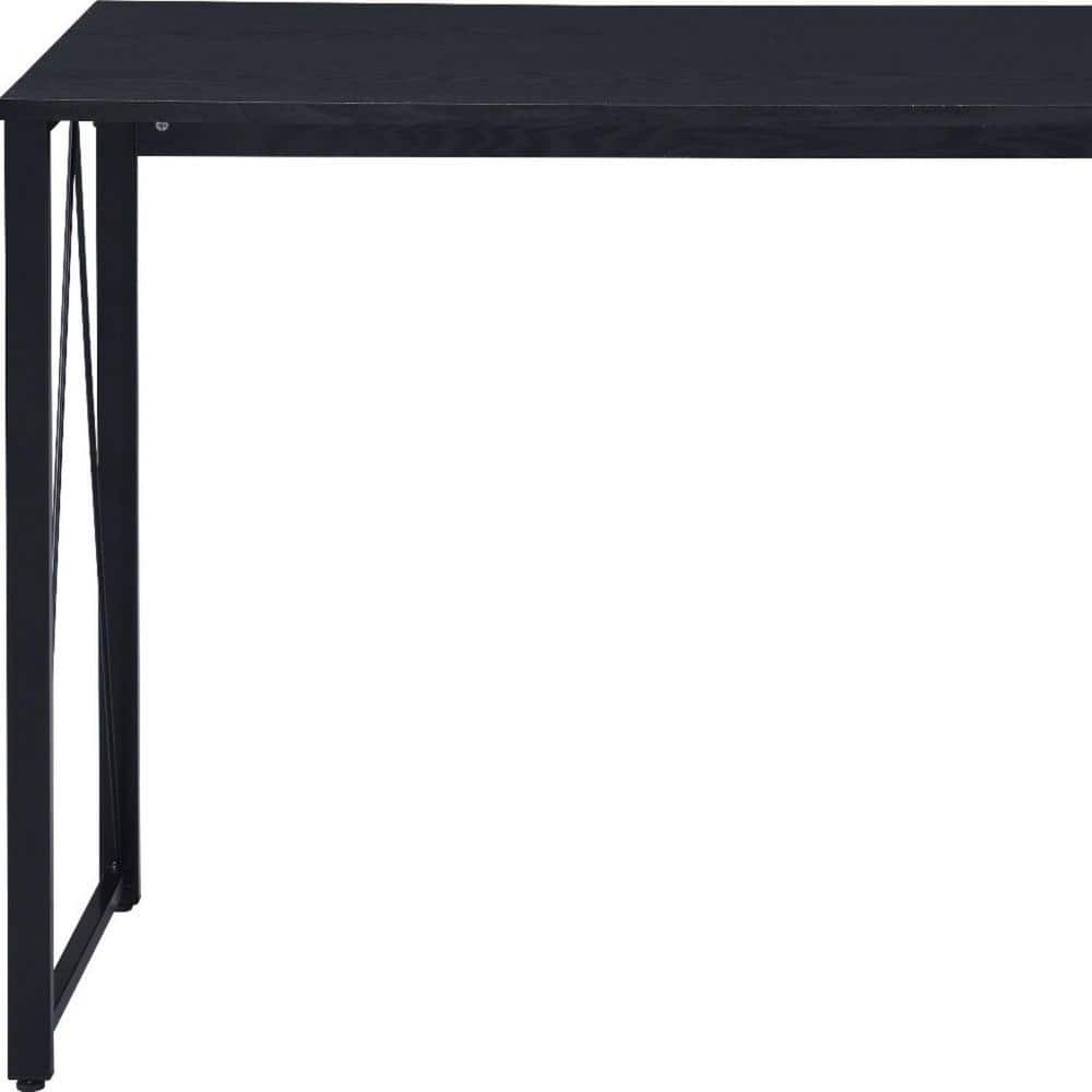 Close-up of the black metal frame and leg of the Homeroots computer desk.