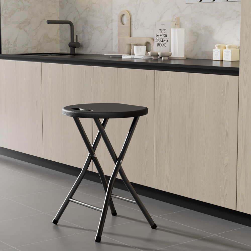 Black folding stool in a modern kitchen.
