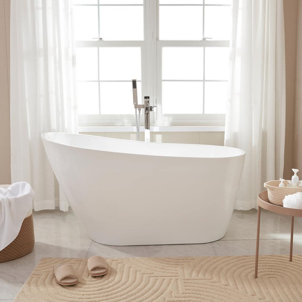 A large luxurious bathroom with a stand alone tub, white vanity