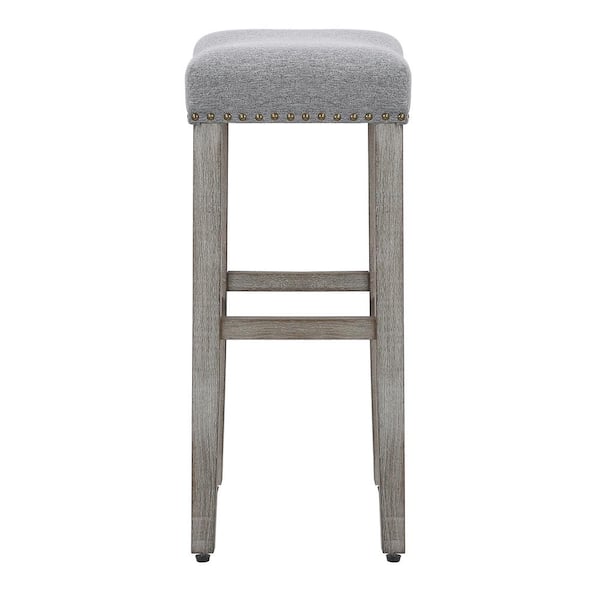 Counter Height Saddle Style Counter Stool With Grey Fabric And Nail Head Trim Counter Height Saddle Style Counter Stool With Grey Fabric And Nail Head Trim