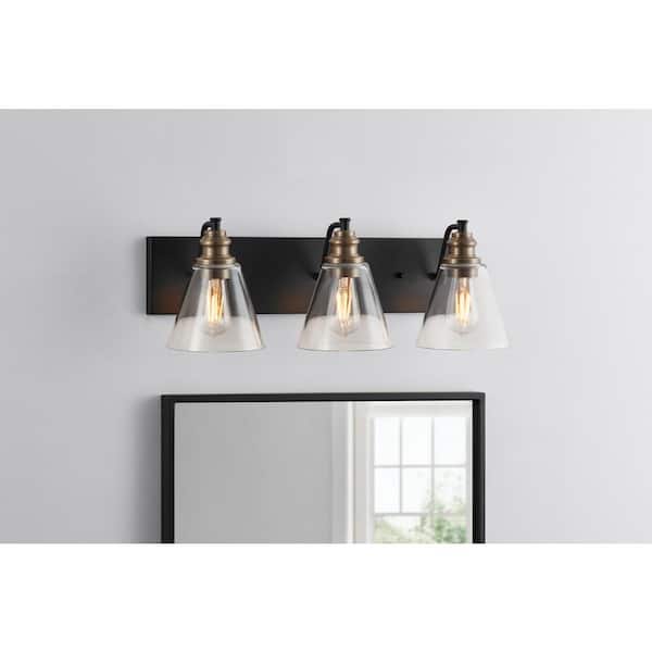 Hampton Bay Manor 24 in. 3-Light Matte Black Industrial Bathroom Vanity Light with Vintage Brass Accents and Clear Glass Shades