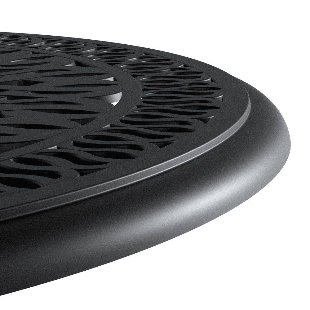 Close-up detail of the black metal table's rim and filigree pattern.