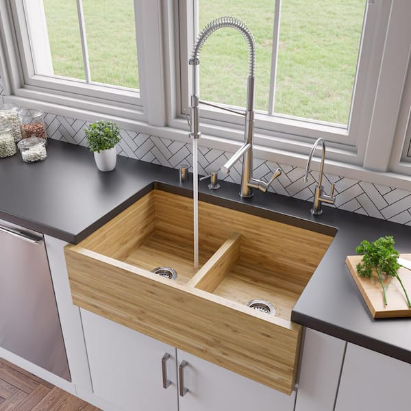 Utensils And Ornaments On Shelf Above Kitchen Sink With Golden Tap