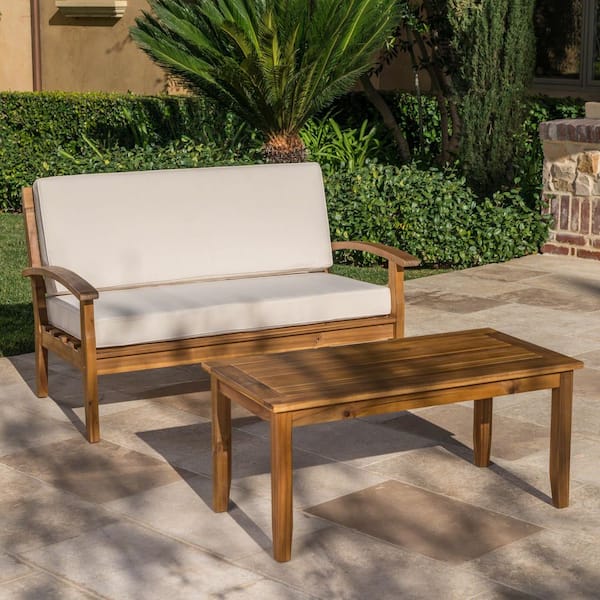 Acacia Wood Outdoor Loveseat with beige Cushions and coffee table