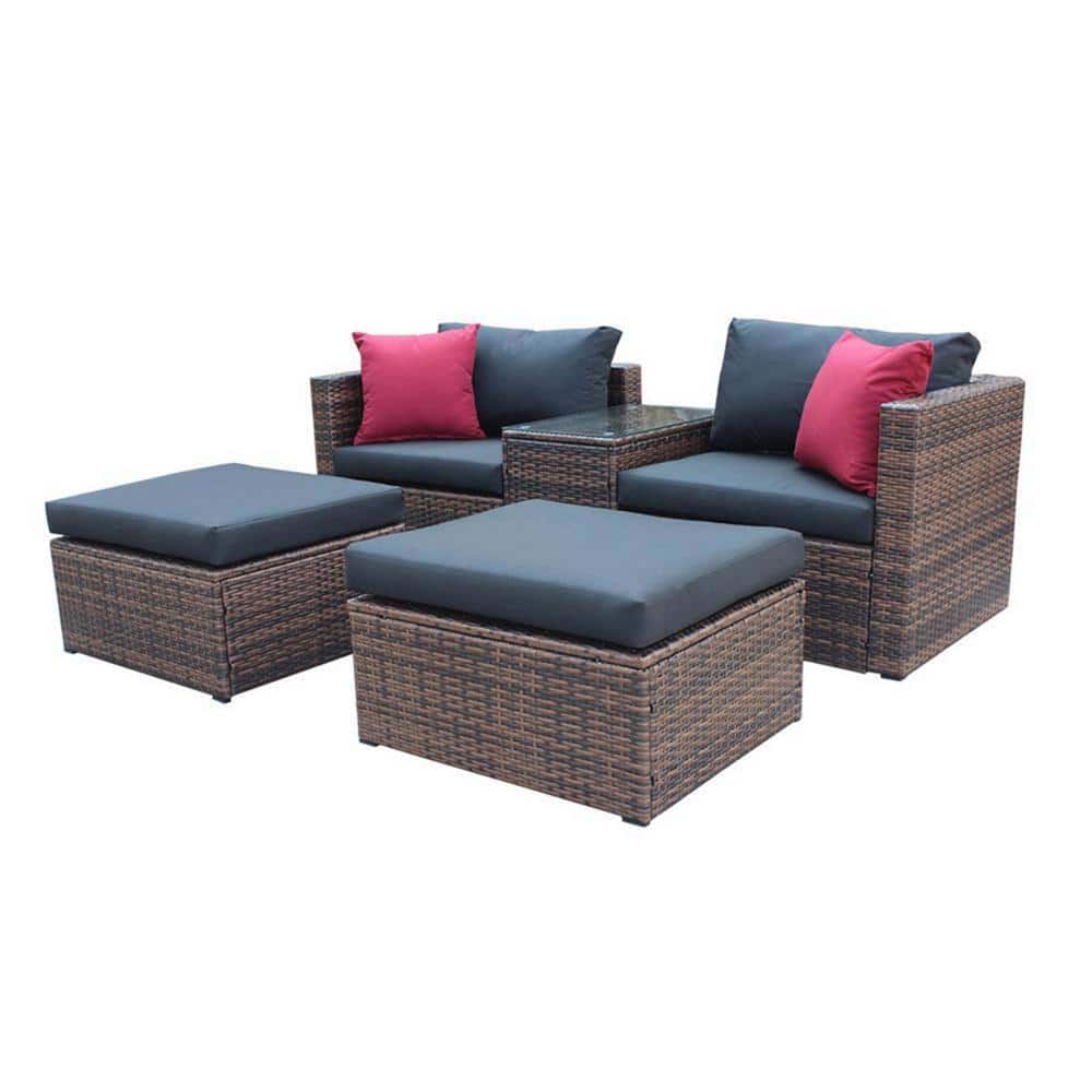 5-piece brown wicker outdoor sectional set with black cushions and red accent pillows.