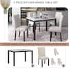 5-piece dining table set with four chairs in a dining room.