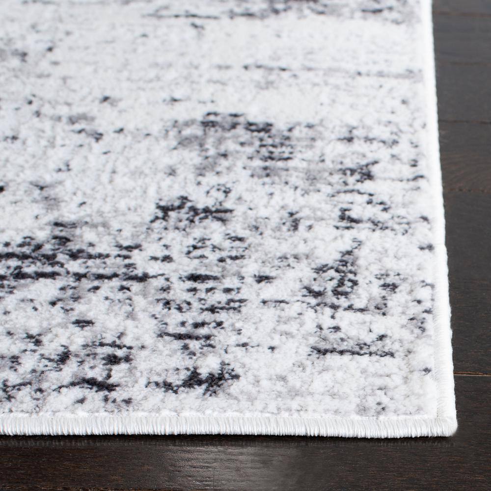 Ivory and Grey Abstract Round Synthetic Rug, 3' x 5'