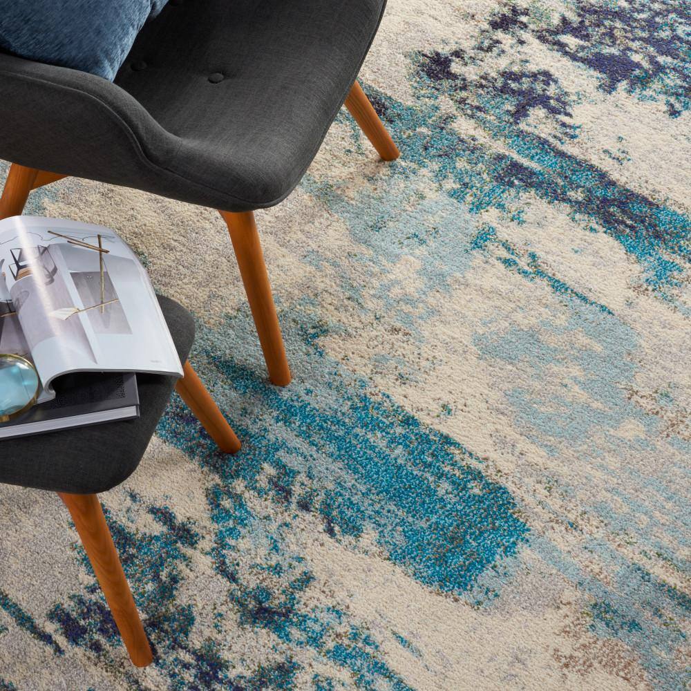 Ivory and Teal Blue Abstract 6' x 9' Synthetic Area Rug