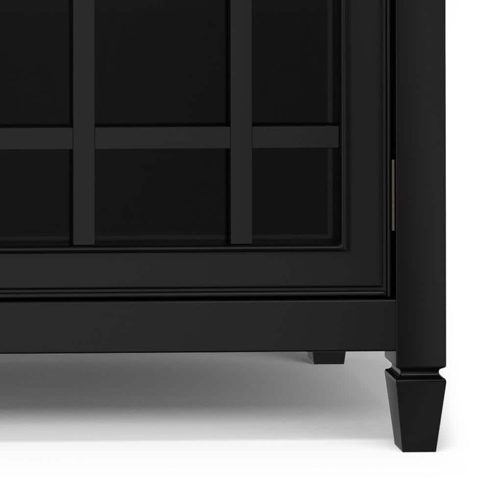 Close-up of the bottom corner and leg of the black storage cabinet.