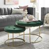Green velvet nesting ottomans placed in a styled living room.