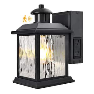 11 in. Black Motion Sensor Dusk to Dawn Outdoor Wall Sconce with Outlet 1-Light Water Rippled Glass Shade Lamp