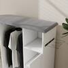 Close-up of the grey ironing board top and the side-mounted iron rack on the white cabinet.