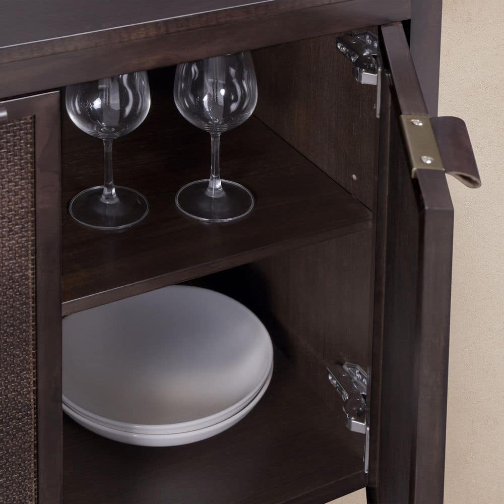 Interior view of the sideboard showing wine glasses and plates.