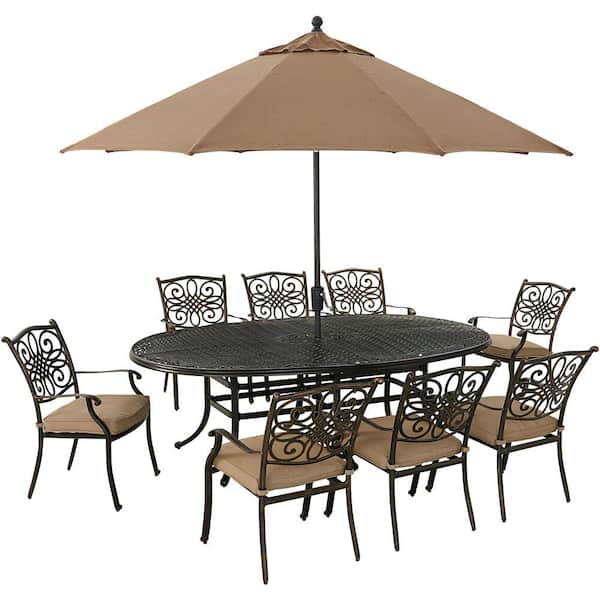Hanover Traditions 9-Piece Aluminum Outdoor Dining Set with Tan Cushions, 8 Chairs, Oval Cast-Top Table, Umbrella and Stand