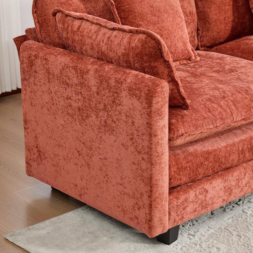 Orange chenille sofa ottoman in a living room.