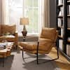 Three-quarter view of a light brown genuine leather accent lounge chair with a black metal frame.
