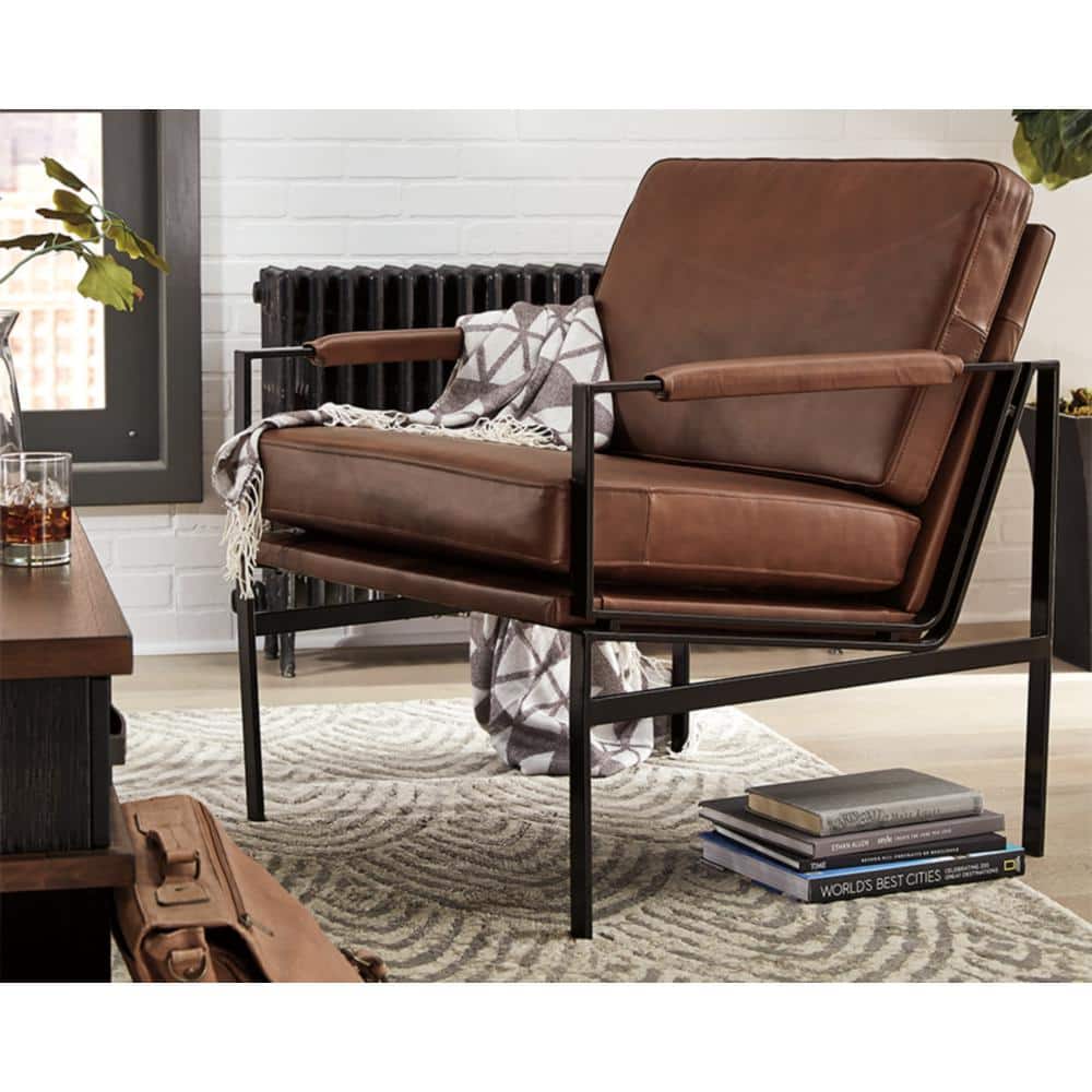 Close-up lifestyle view of the brown leather arm chair.