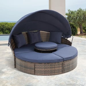 Brown KD Wicker Outdoor Round Sofa Day Bed with 4 Navy Blue Cushions and 3 Pillows with Canopy and Lift Up Coffee Table