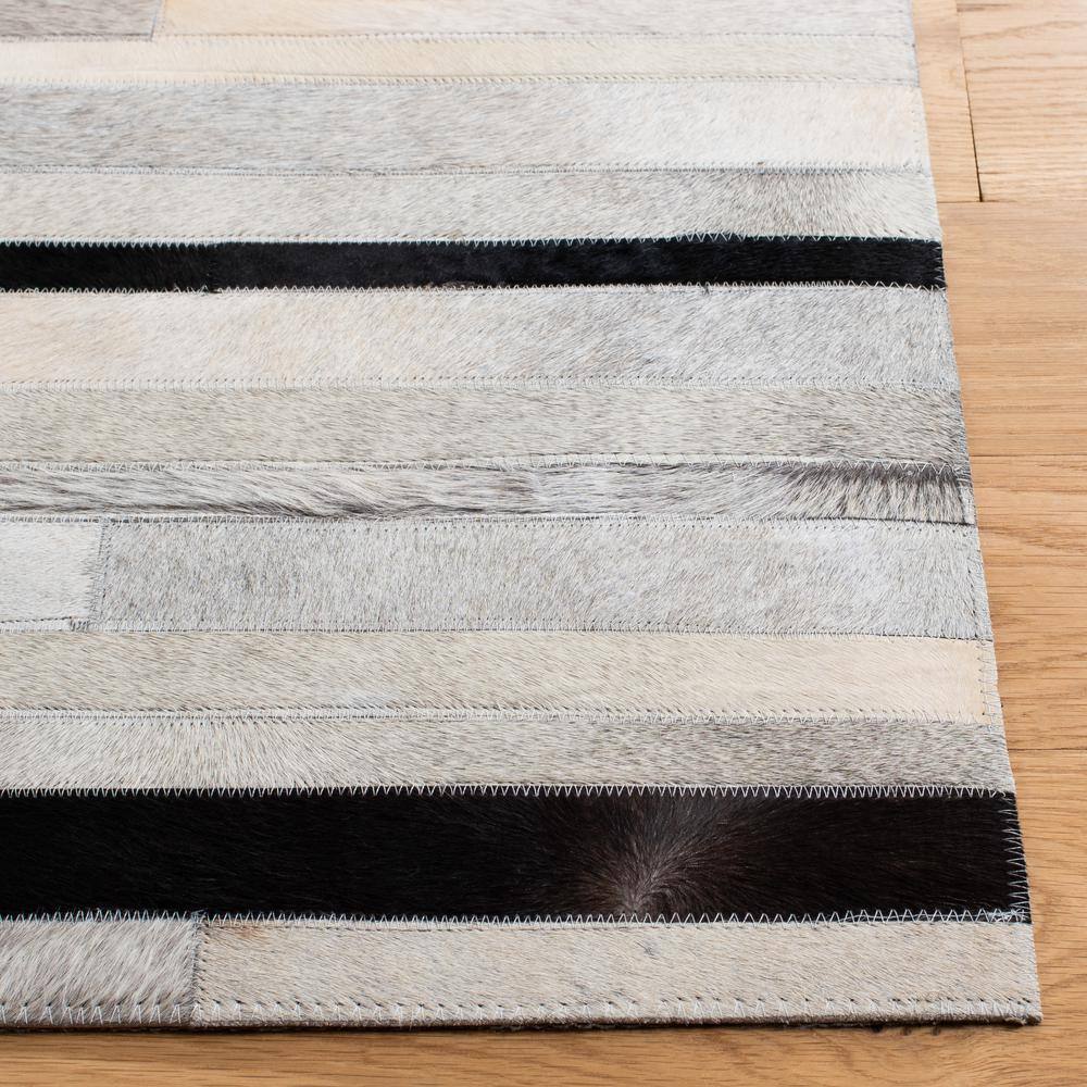 Handmade Black and Ivory Geometric Cowhide Area Rug