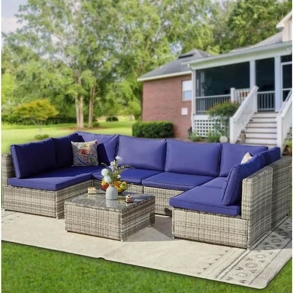 7-Piece Light Grey Wicker Outdoor Sectional Sofa Set with Navy Blue Cushions and Ottomans