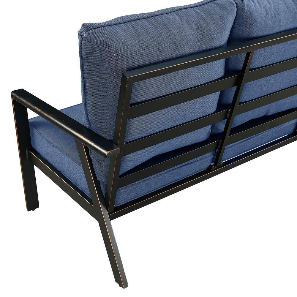 Close-up view of the black aluminum frame and blue cushions of the outdoor couch.