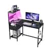 Black computer desk with RGB lighting effect.