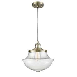 Oxford 1-Light Antique Brass Schoolhouse Pendant Light with Seedy Glass Shade