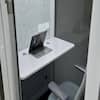 Phone booth with laptop set up inside.