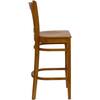 Side view of a cherry wood bar stool.