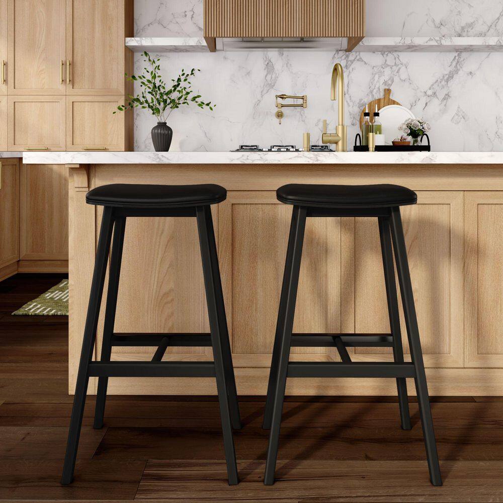 Two black bar stools at a kitchen island.