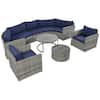 Gray wicker outdoor sectional sofa set with blue cushions and coffee tables.