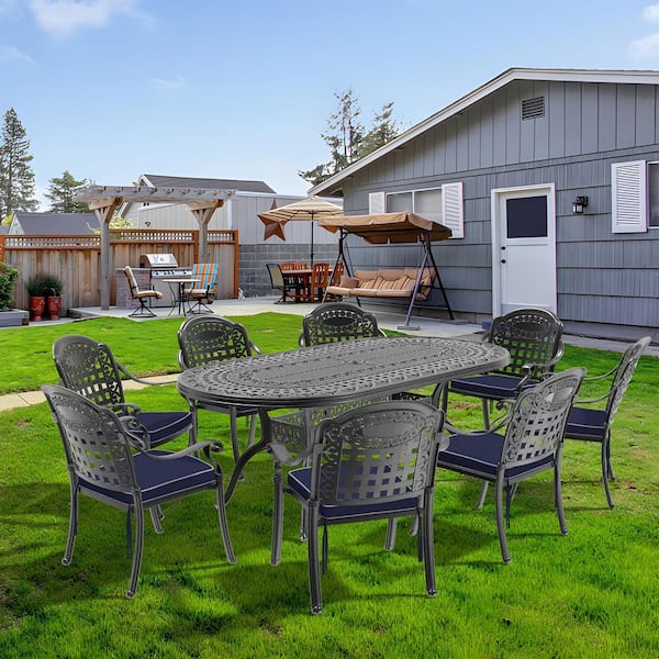Black 9-Piece Cast Aluminum Oval Bar Height Outdoor Dining Set with Blue Cushions Durable Construction